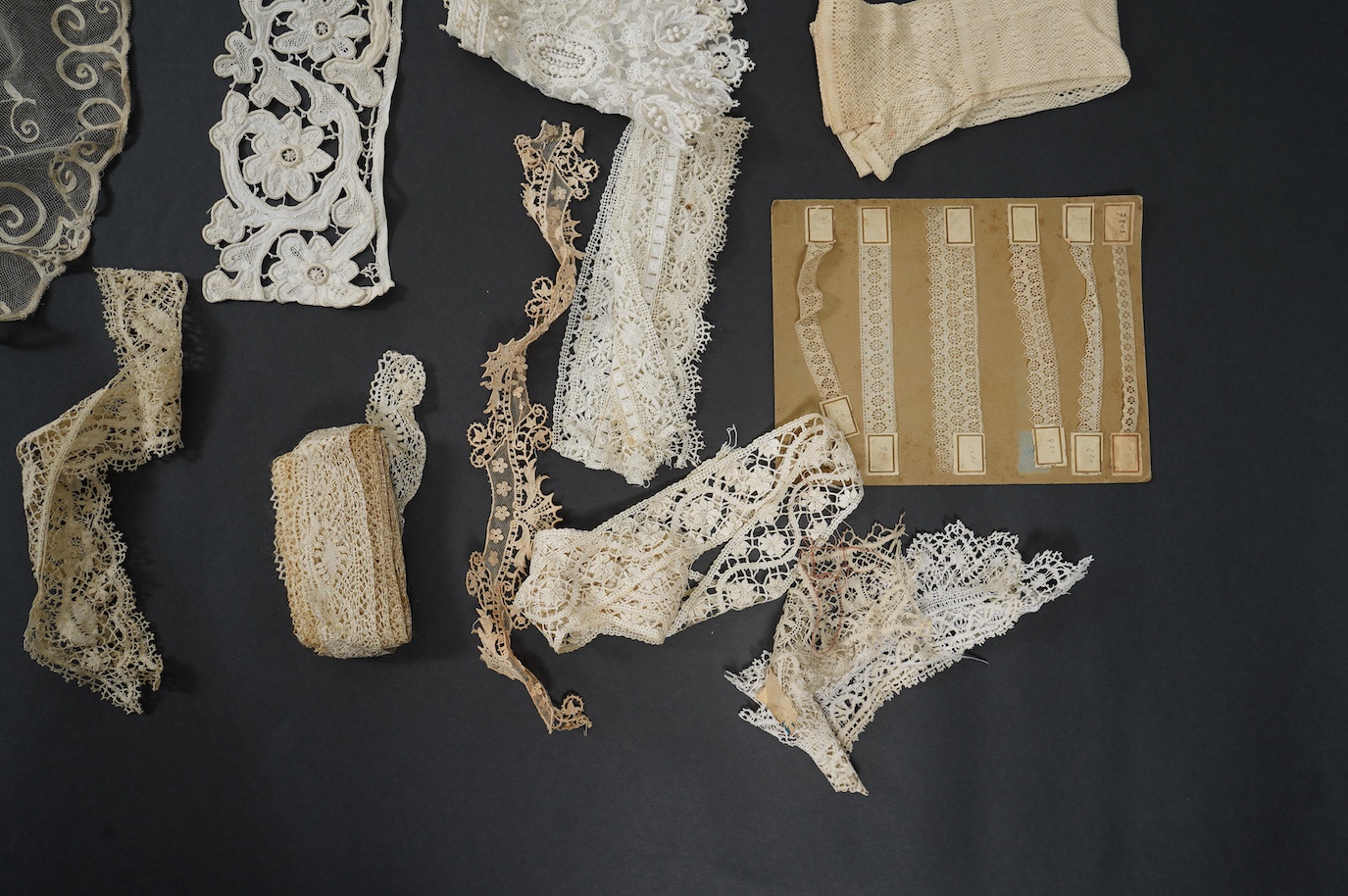 A needle run embroidered net skirt, a similar Bertha, five large silk Maltese bobbin lace collars and trimming, a length of Venetian style lace, mittens etc. Condition - good